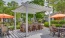 pergola over a grill and high-top chairs