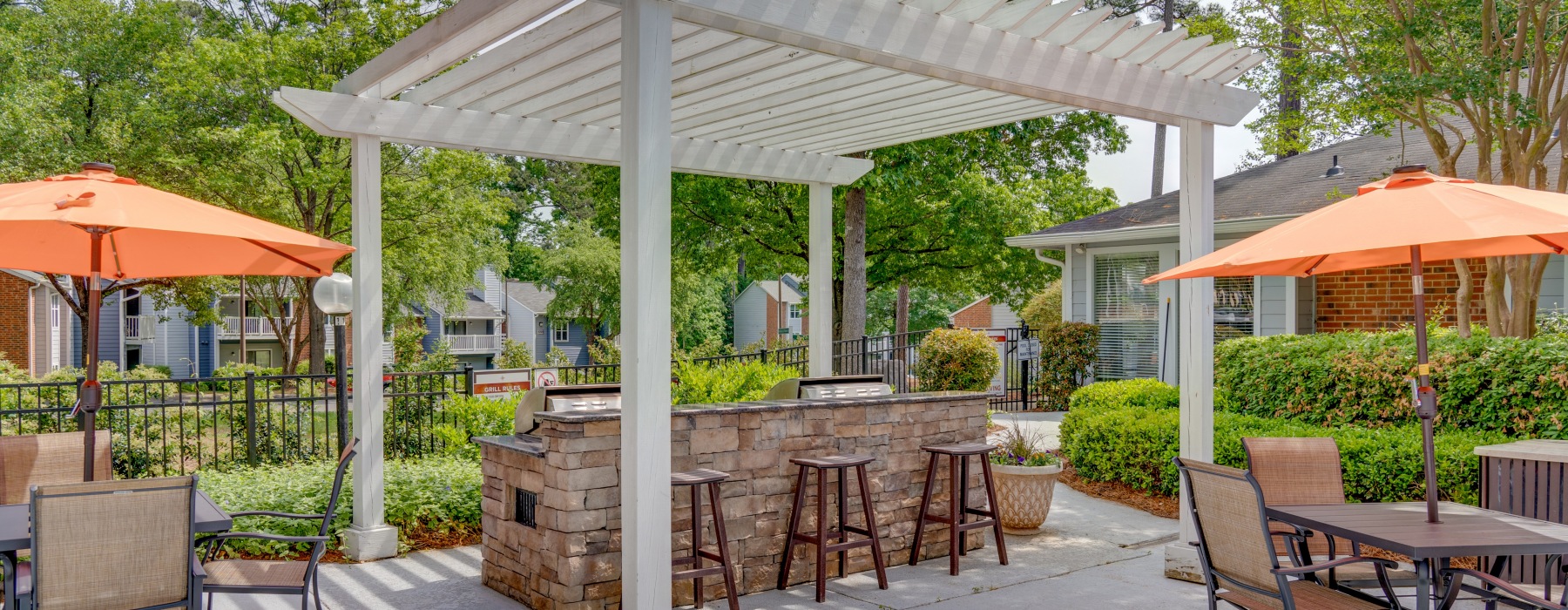 pergola over a grill and high-top chairs