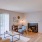 living room with a desk, chairs, and a fireplace