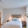 bedroom with hardwood floors and a walk-in closet